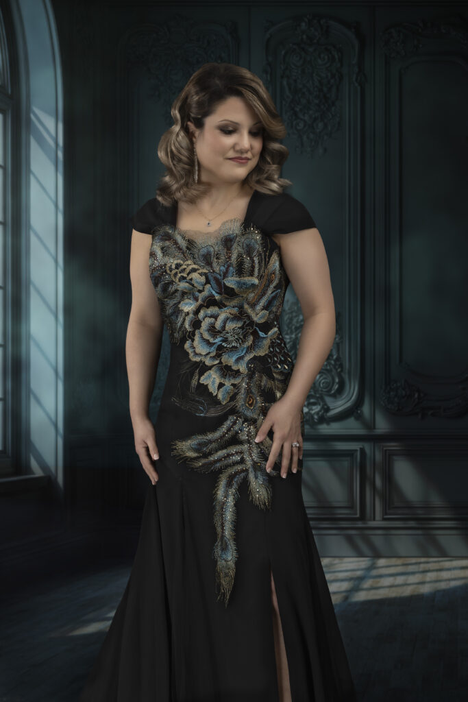 Blue window light highlighting a beautiful woman dress in a peacock blue dress