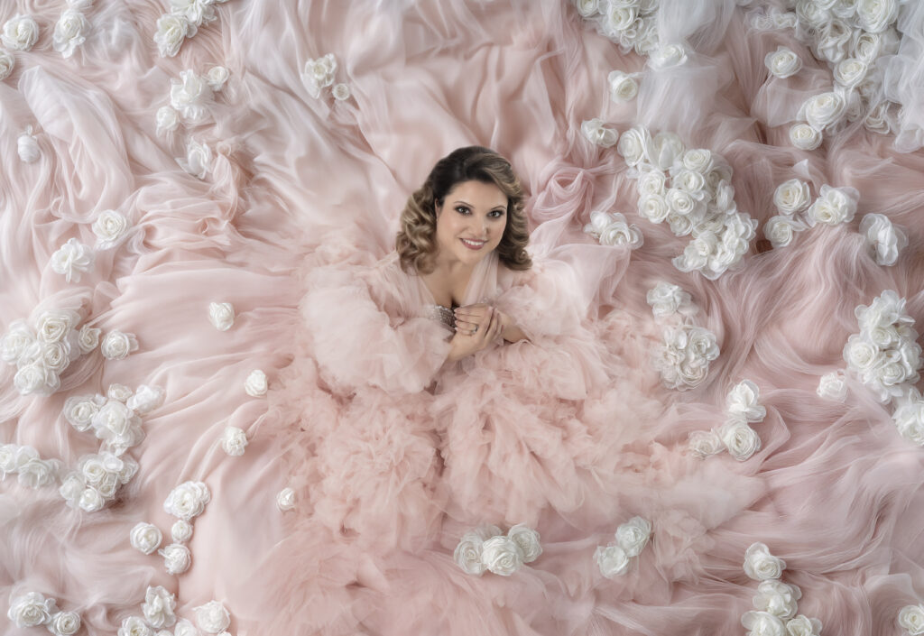 White roses in a bed of pink tulle glamour boudoir photography
